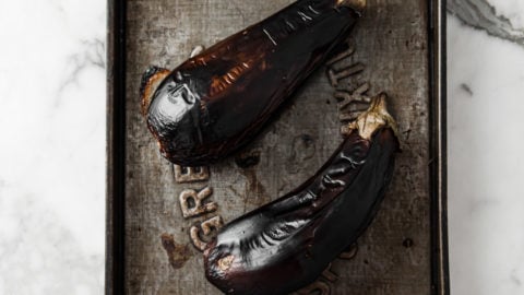 Oven-Roasted (broiled) eggplants with charred skin in a bowl
