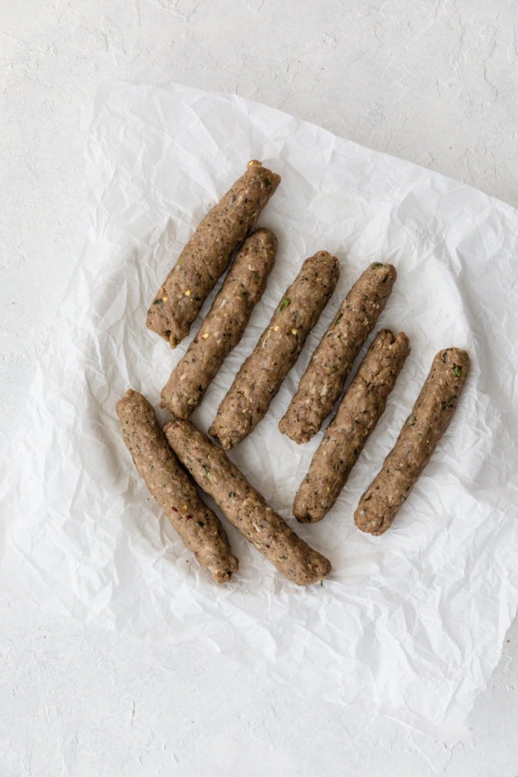 Shaped, raw seekh kebab ready to be cooked