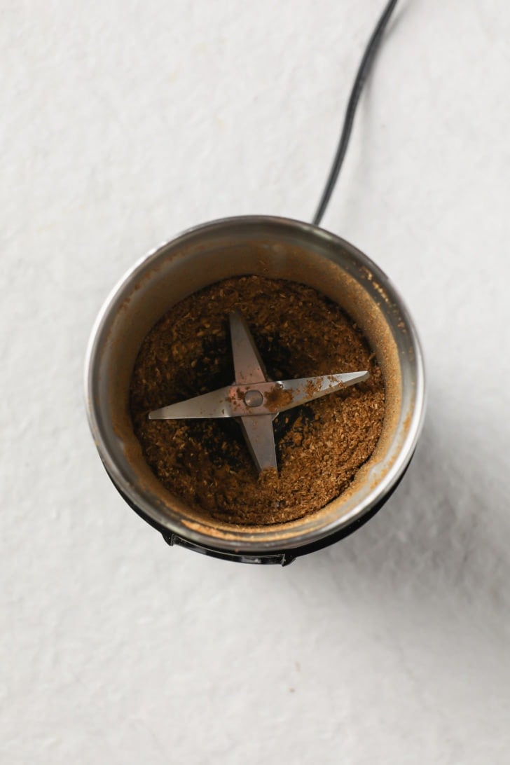 Ground toasted coriander seeds in a spice grinder
