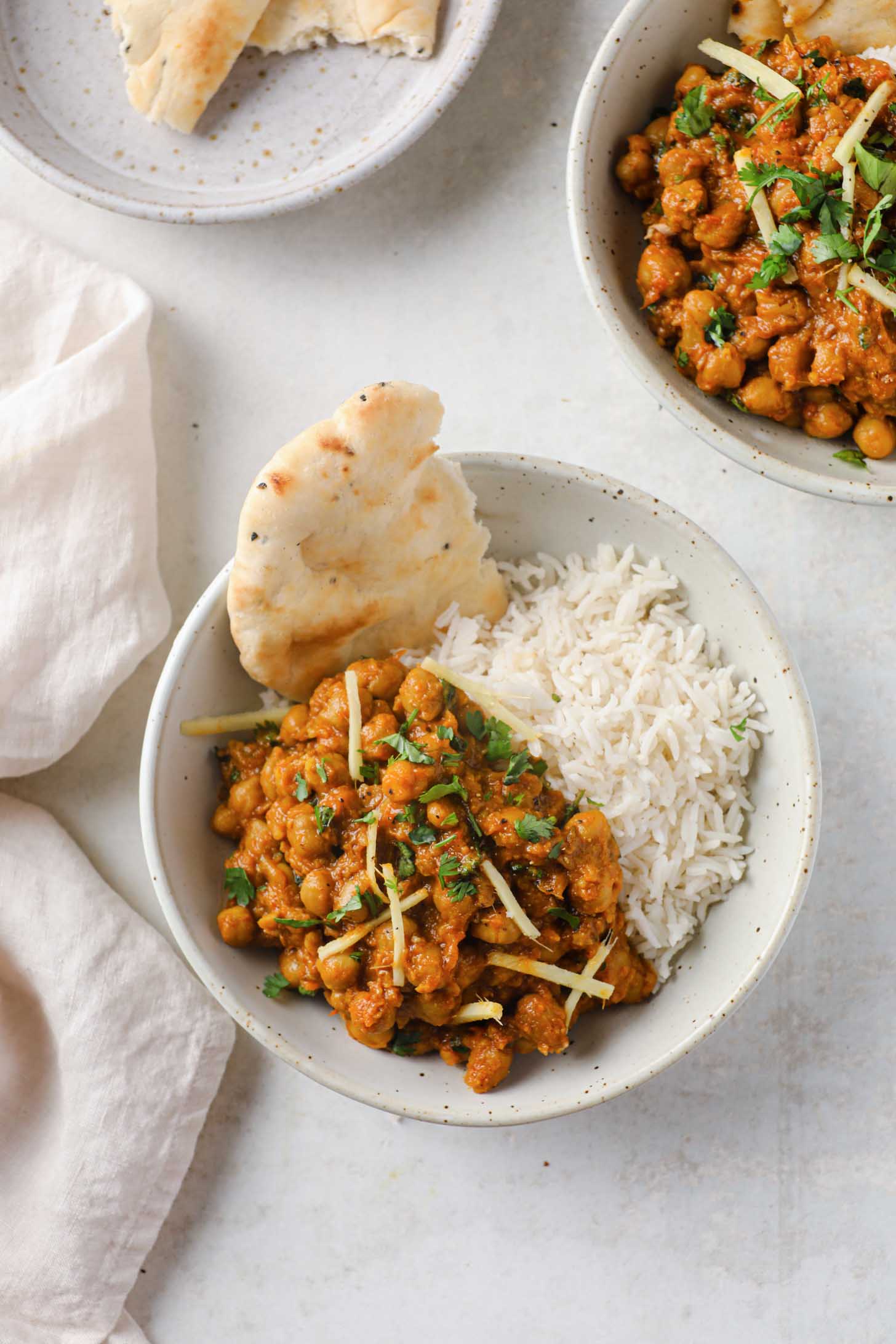 Indian Chickpea Curry in a bowl with rice and naan