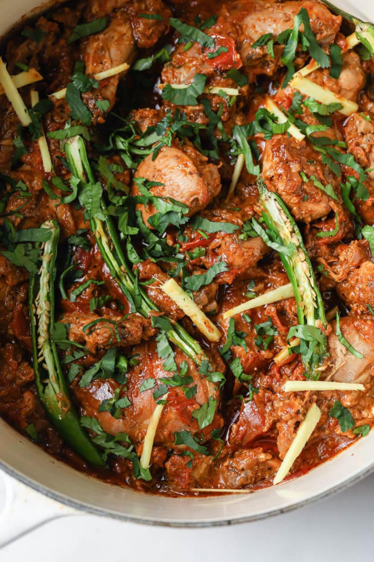 Closeup of finished chicken karahi in a white pan