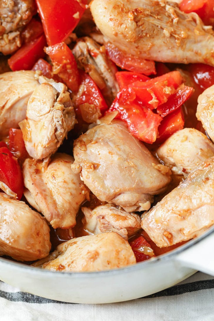 Tomatoes added to sauteed chicken
