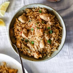 Instant Pot Chicken Pulao in a bowl garnished with cilantro.