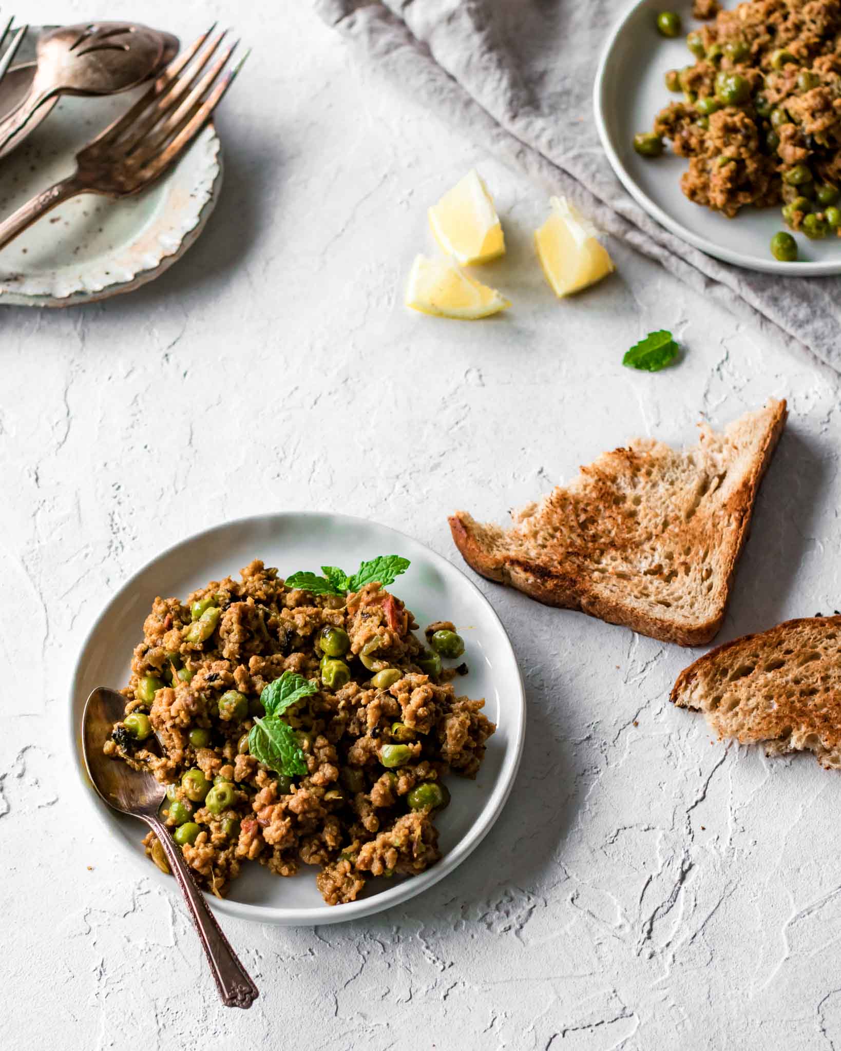 Keema Matar (ground beef and peas) with bread and lemon wedges