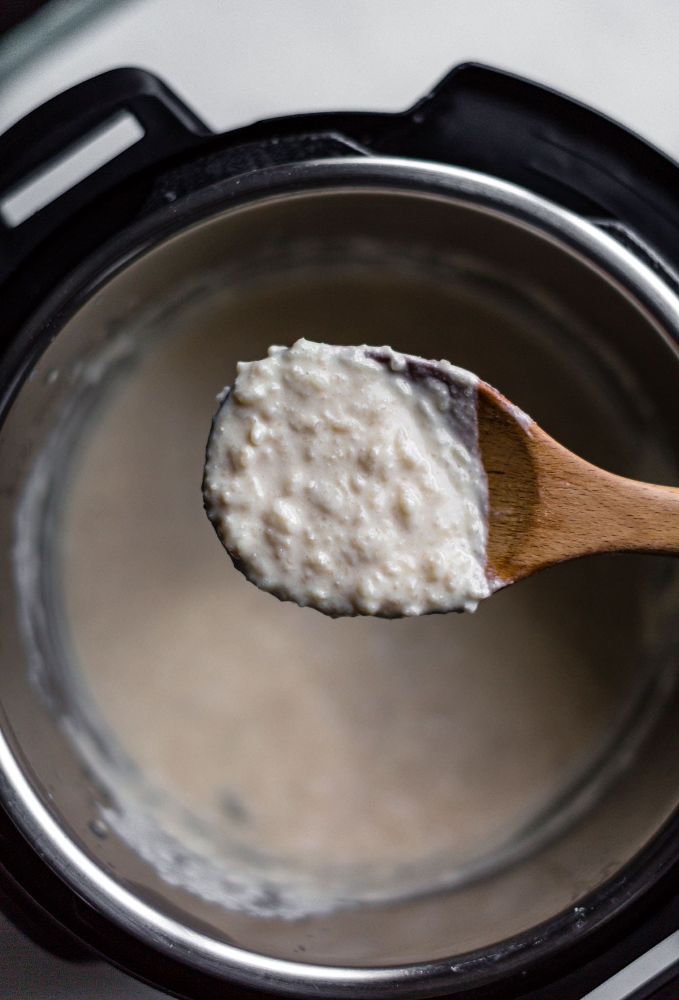 Showing texture of Instant Pot kheer on a wooden spoon