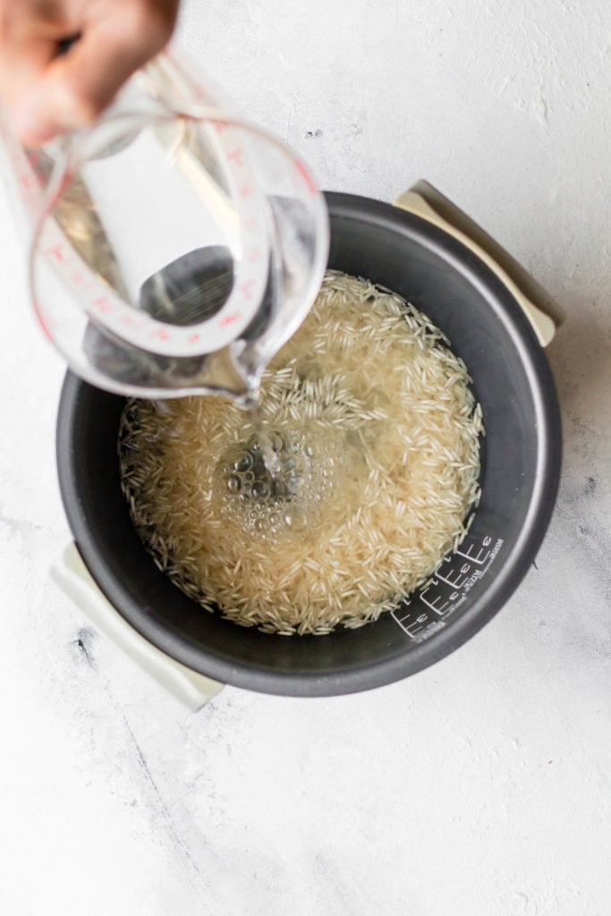 Pour water into the rice cooker to make Basmati rice