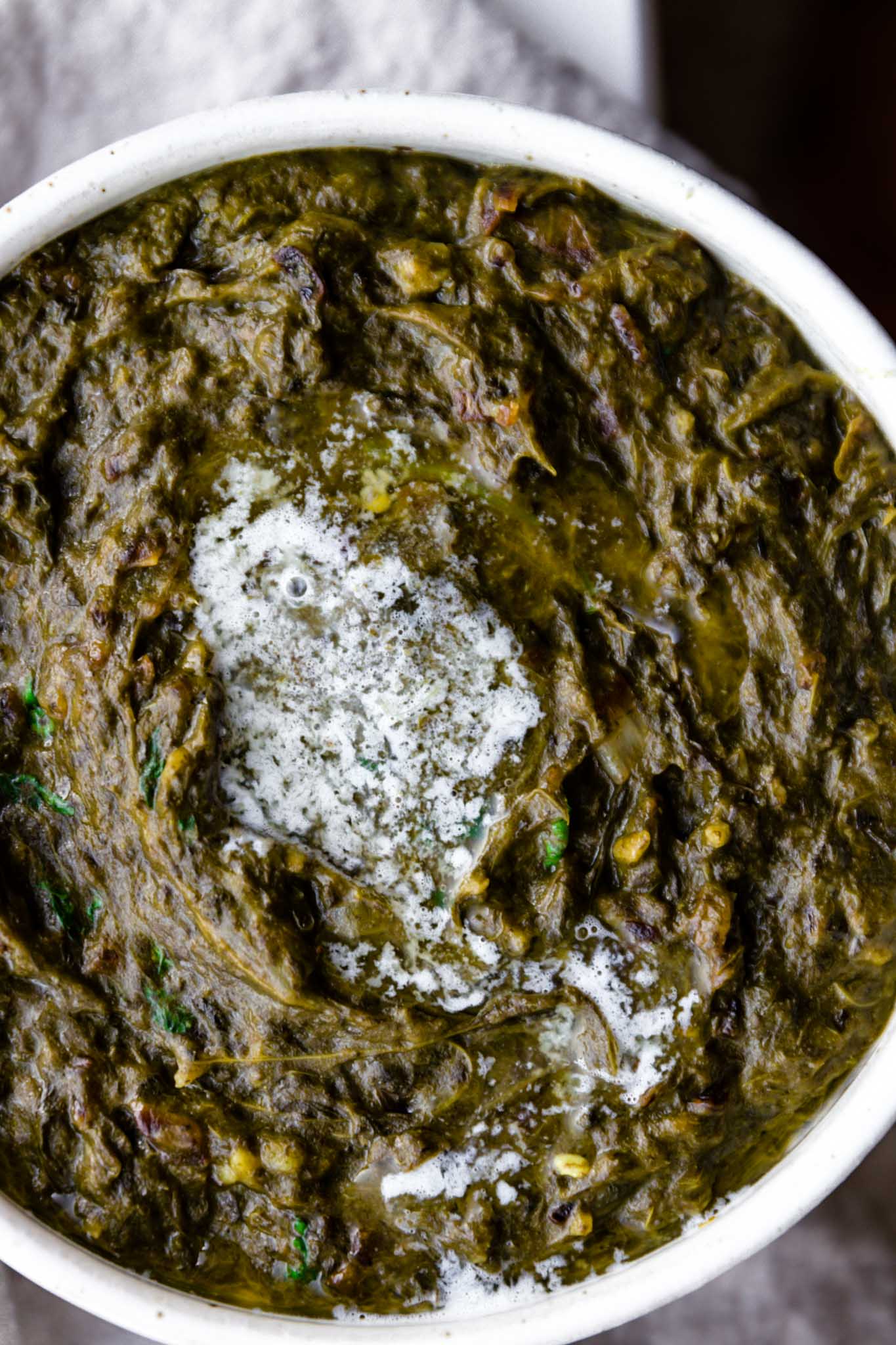 Close up of Sarson Ka Saag with a dollop of melted butter