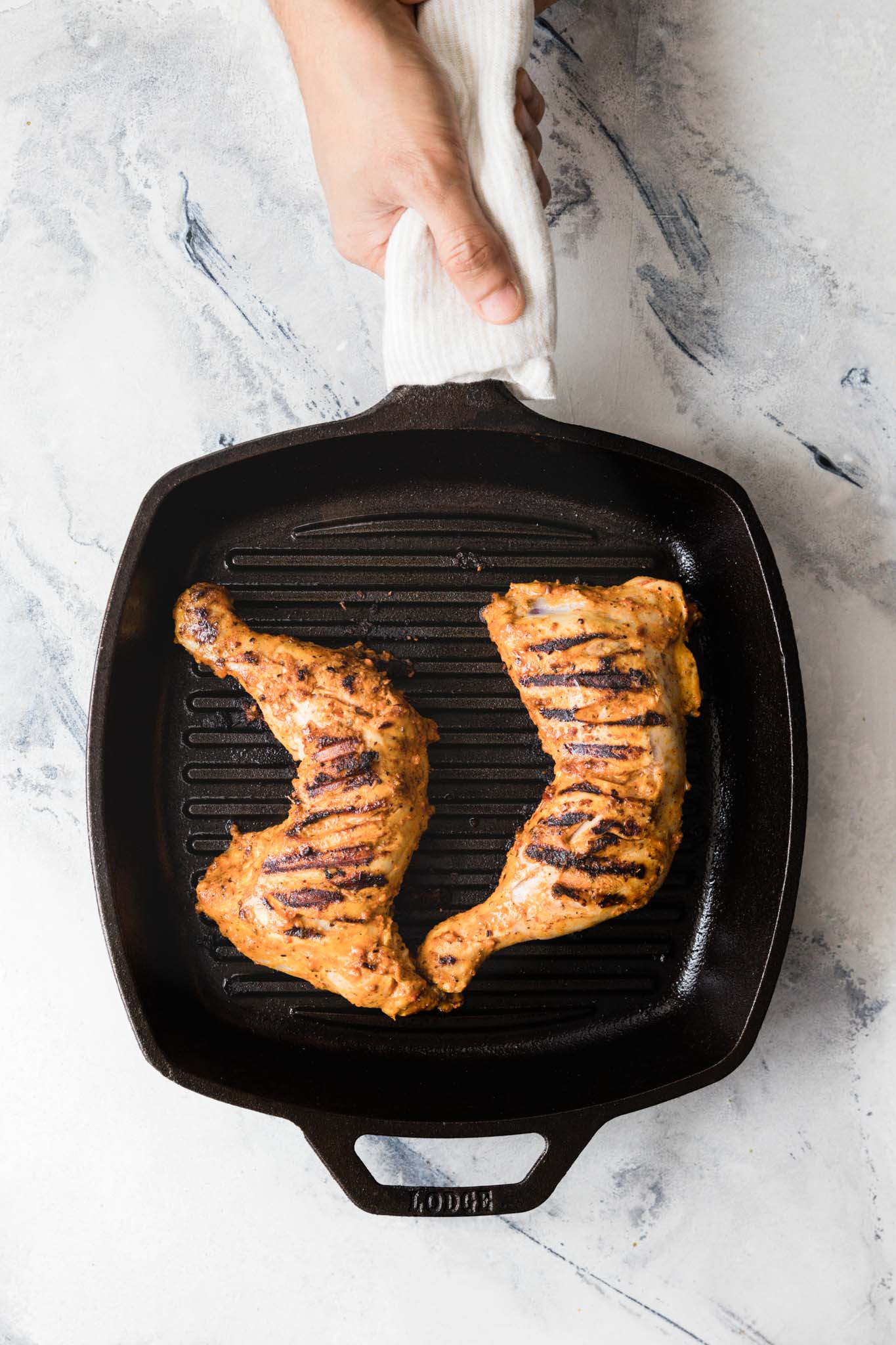 Holding a grill pan with chicken leg quarters