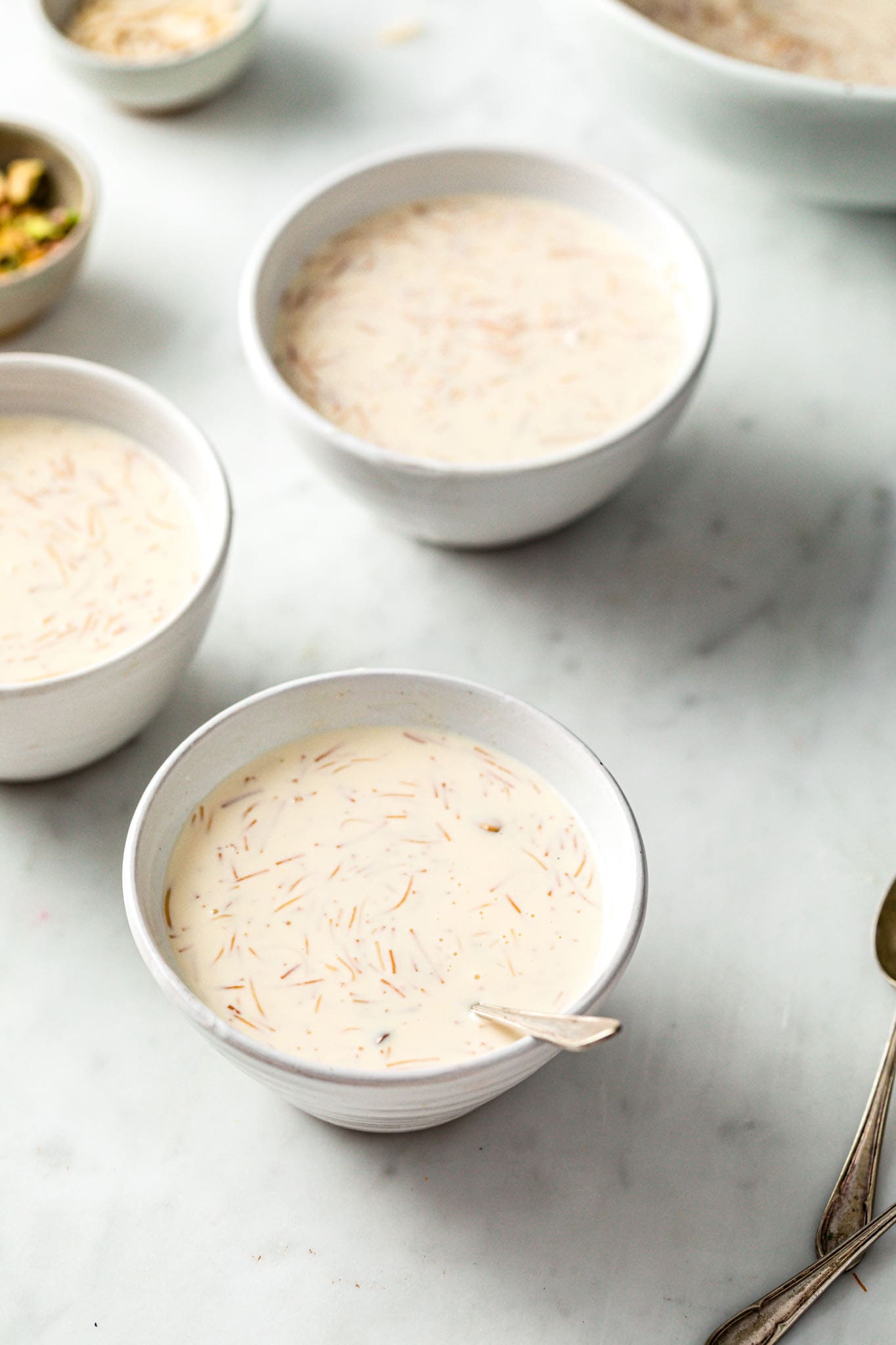 White bowls with milky, creamy sheer khurma 