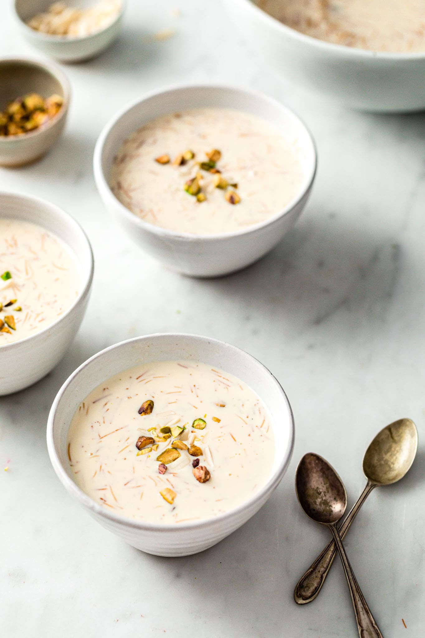 Creamy Seviyan in small bowls garnished with almonds and pistachios