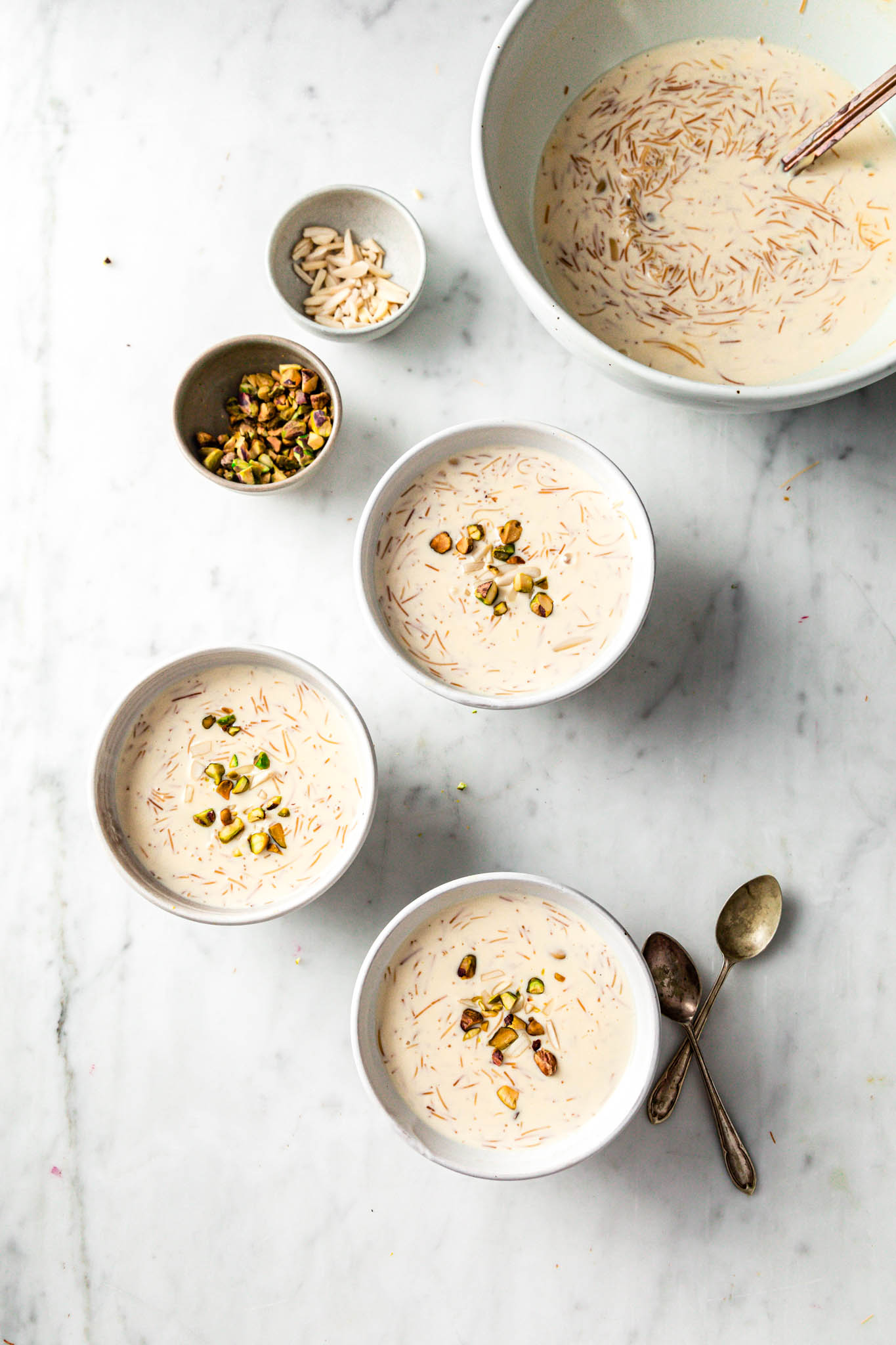 White bowls filled with vermicelli pudding and garnished with nuts 