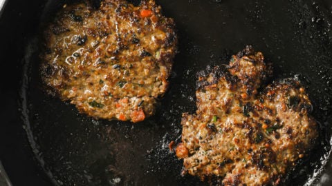 Frying Chapli Kabab in a cast iron skillet.