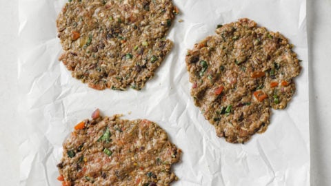 Chapli Kabab Patties on parchment paper ready to be fried.