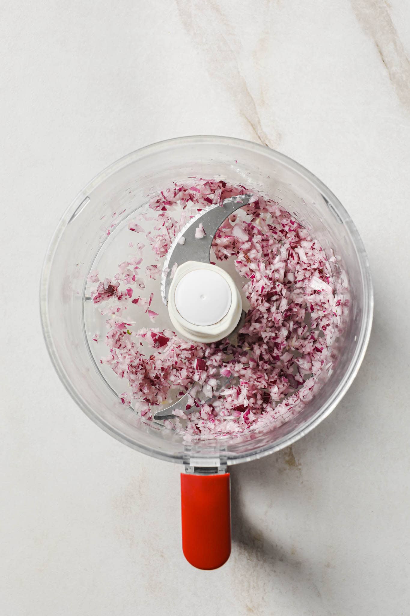 Finely chopped red onions in a food processor.