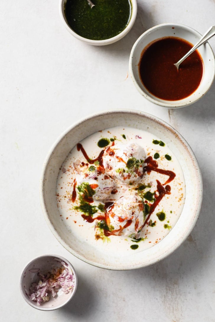 Dahi Bhalla (Dahi Bharay) served in a bowl with toppings on the side.