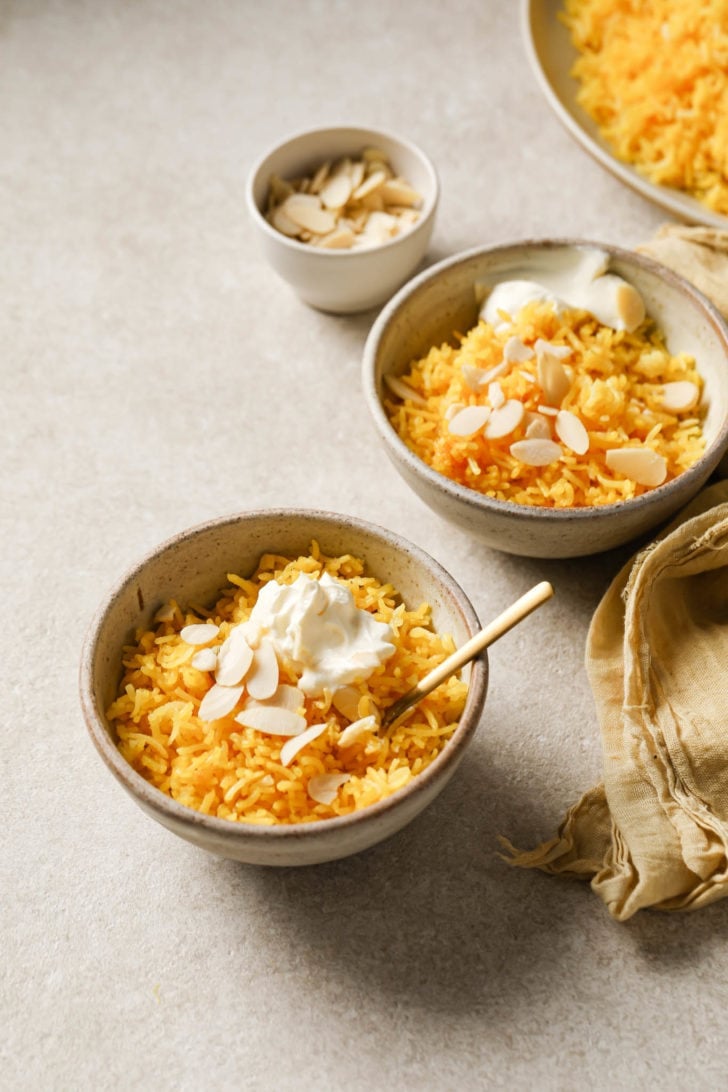 Bowls of Zarda served with almonds and malai.