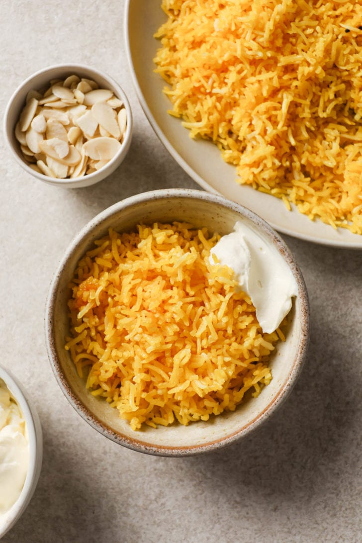 A bowl of Zarda with cream on the side.