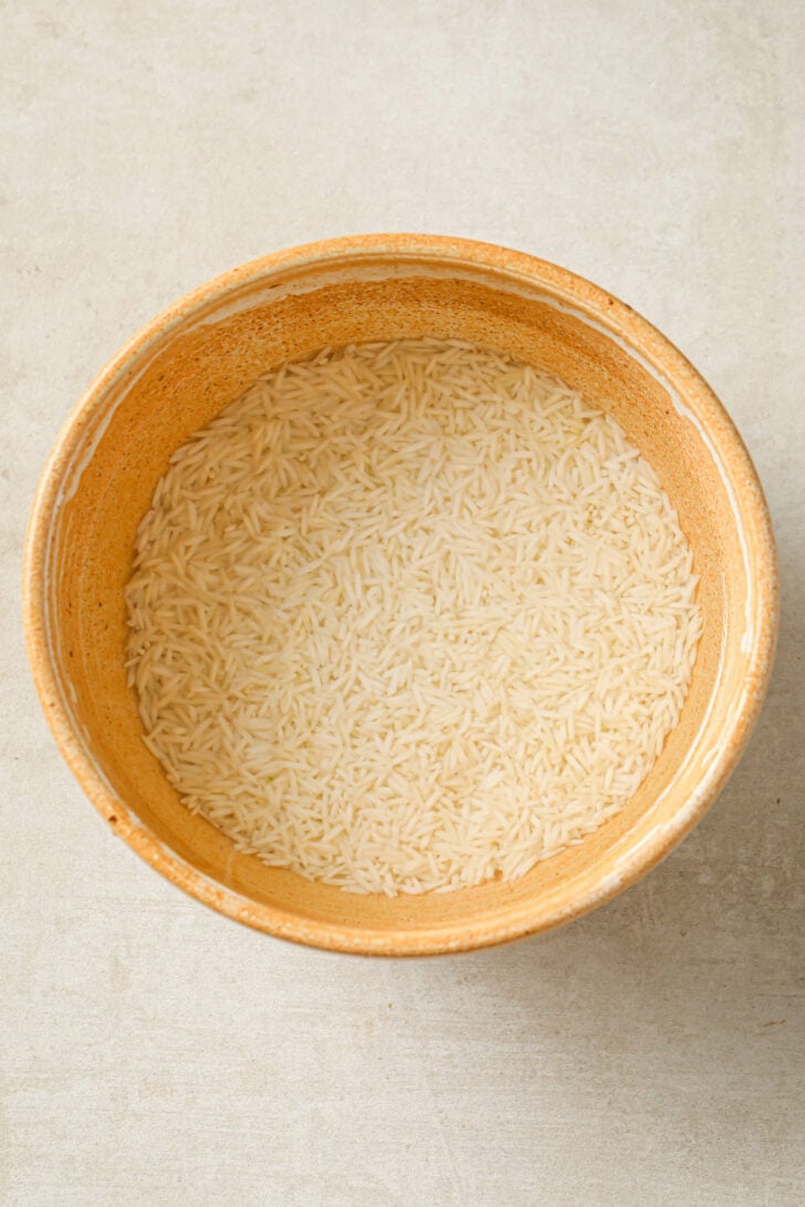 Soaked basmati rice in a bowl.