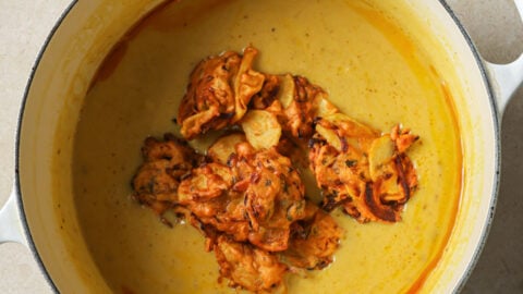 Fried pakoras added to kadhi.