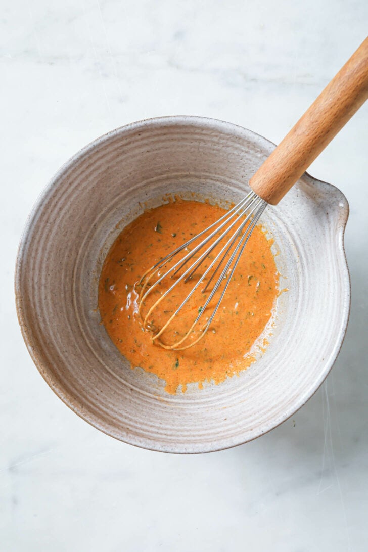 Tandoori marinade in a bowl with a whisk.