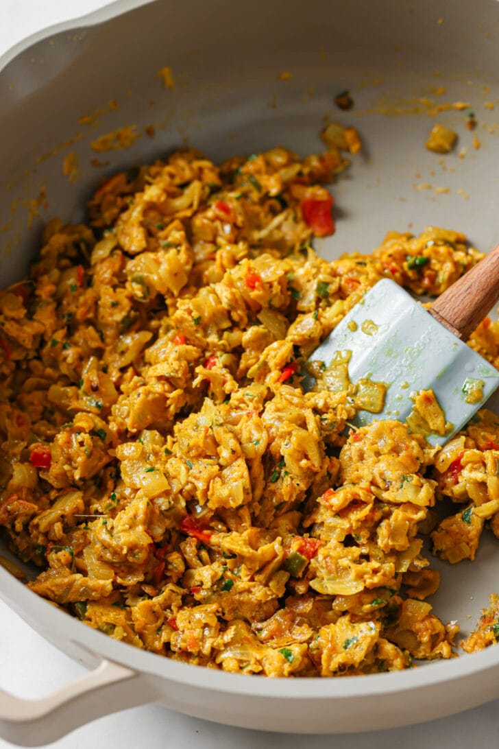 Close up of cooked Egg Bhurji in a skillet with a rubber spatula.
