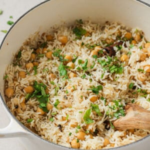 Chana Pulao in a Dutch Oven garnished with cilantro.