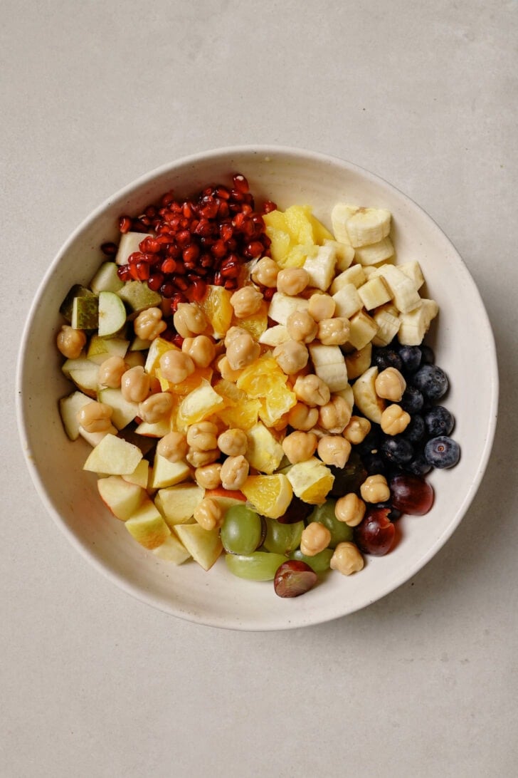 Chopped fruit and chickpeas in a bowl to make Fruit Chaat.