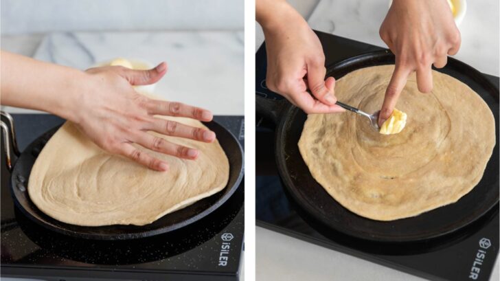 Placing rolled out dough on tawa and applying some butter.
